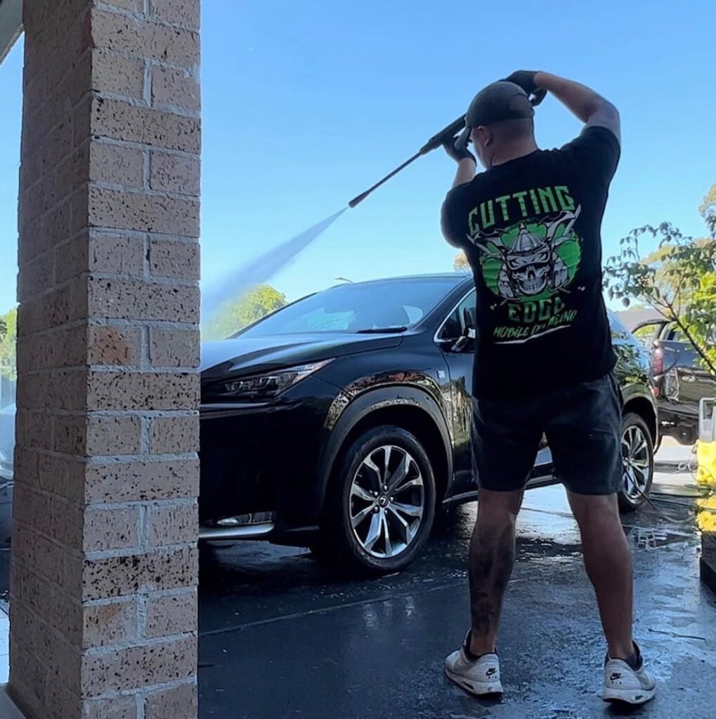 Mobile car detailing technician working on vehicle exterior in Sydney